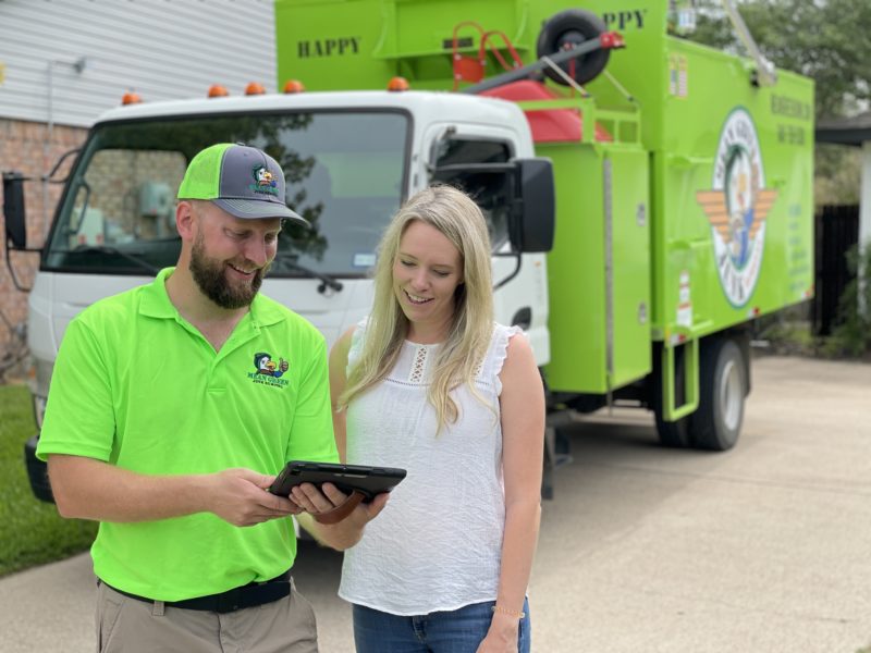 Mean Green Junk Removal expert quoting customer