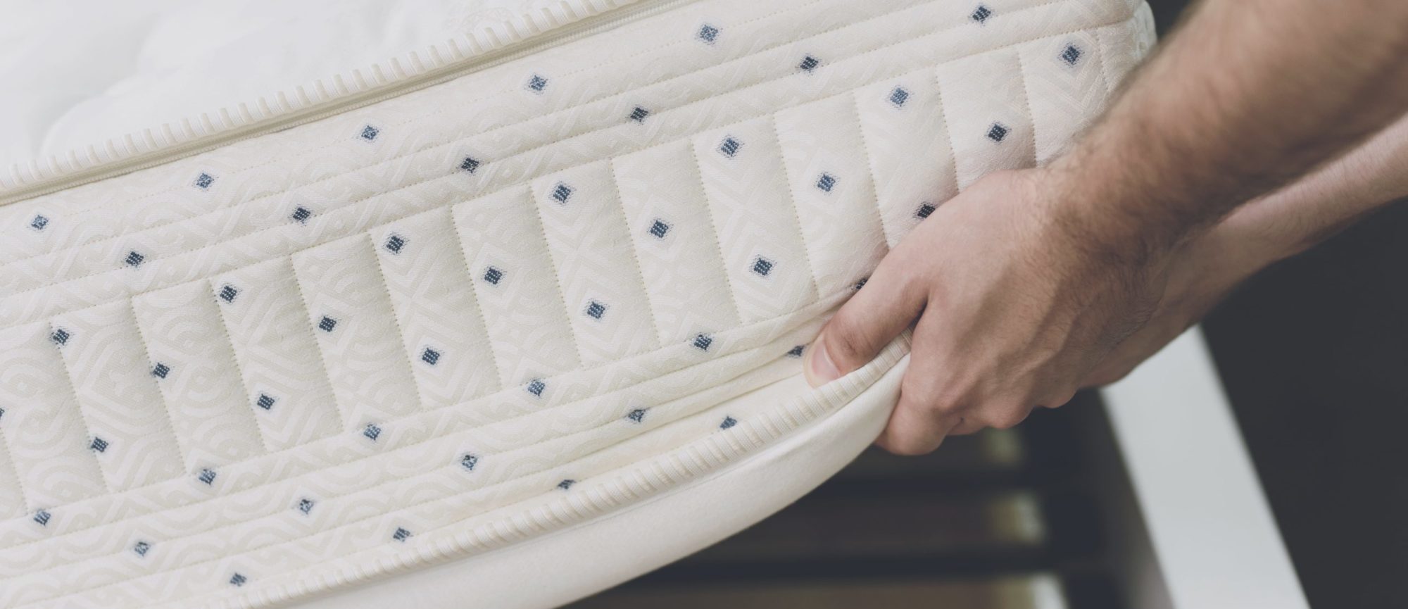 Person lifting a mattress for residential old mattress removal and disposal.