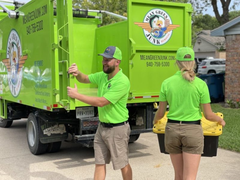 mean green team opening junk truck doors for move out junk removal