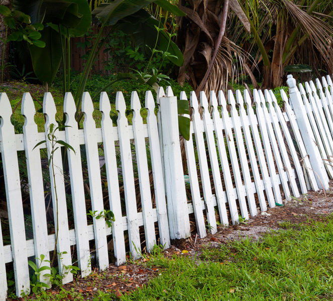 white fence that is old that needs to be removed