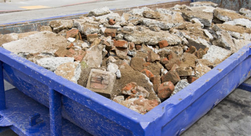 bin filled with broken gravel ready for junk removal