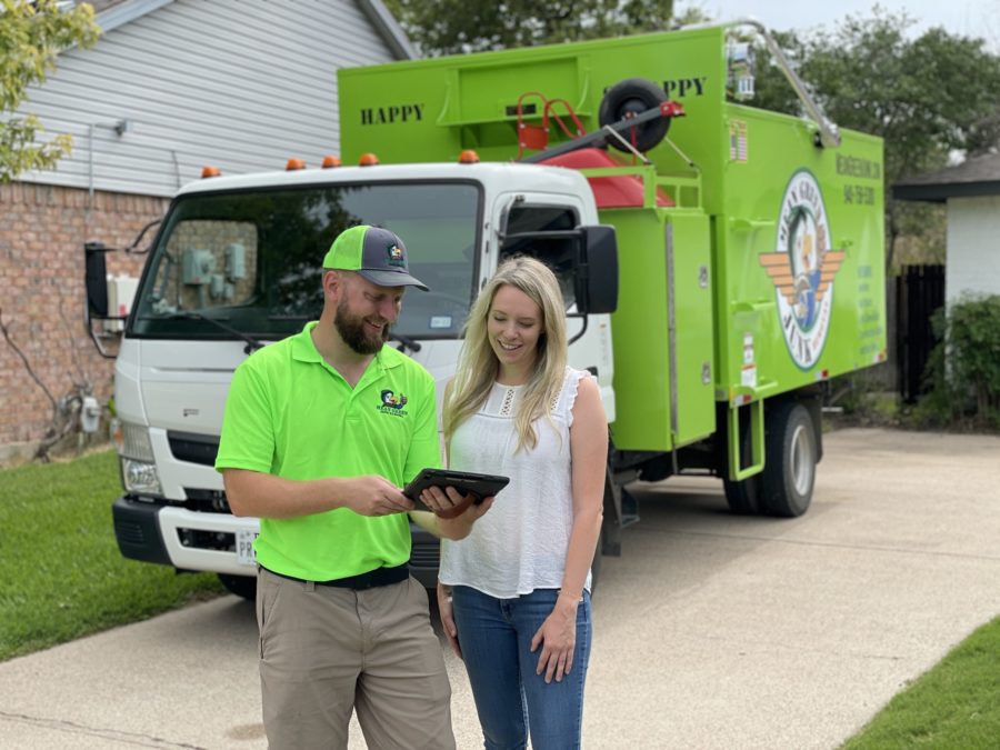 mean green junk removal pro smiling with customer