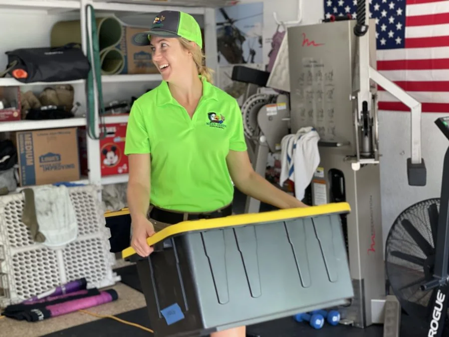 Person holding a storage container indoors.