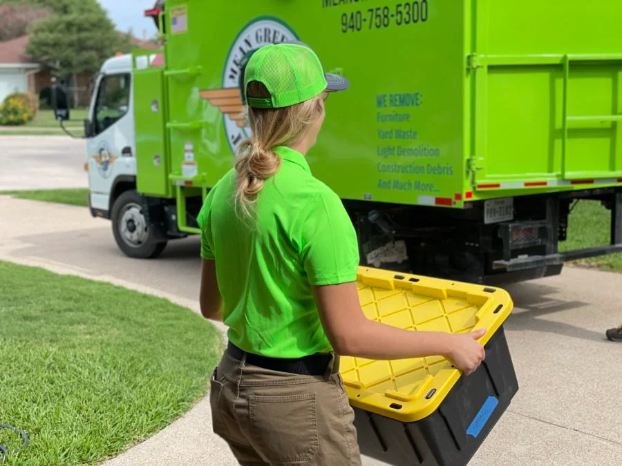 mean-green-junk-removal-pro-carrying-box-to-junk-removal-truck